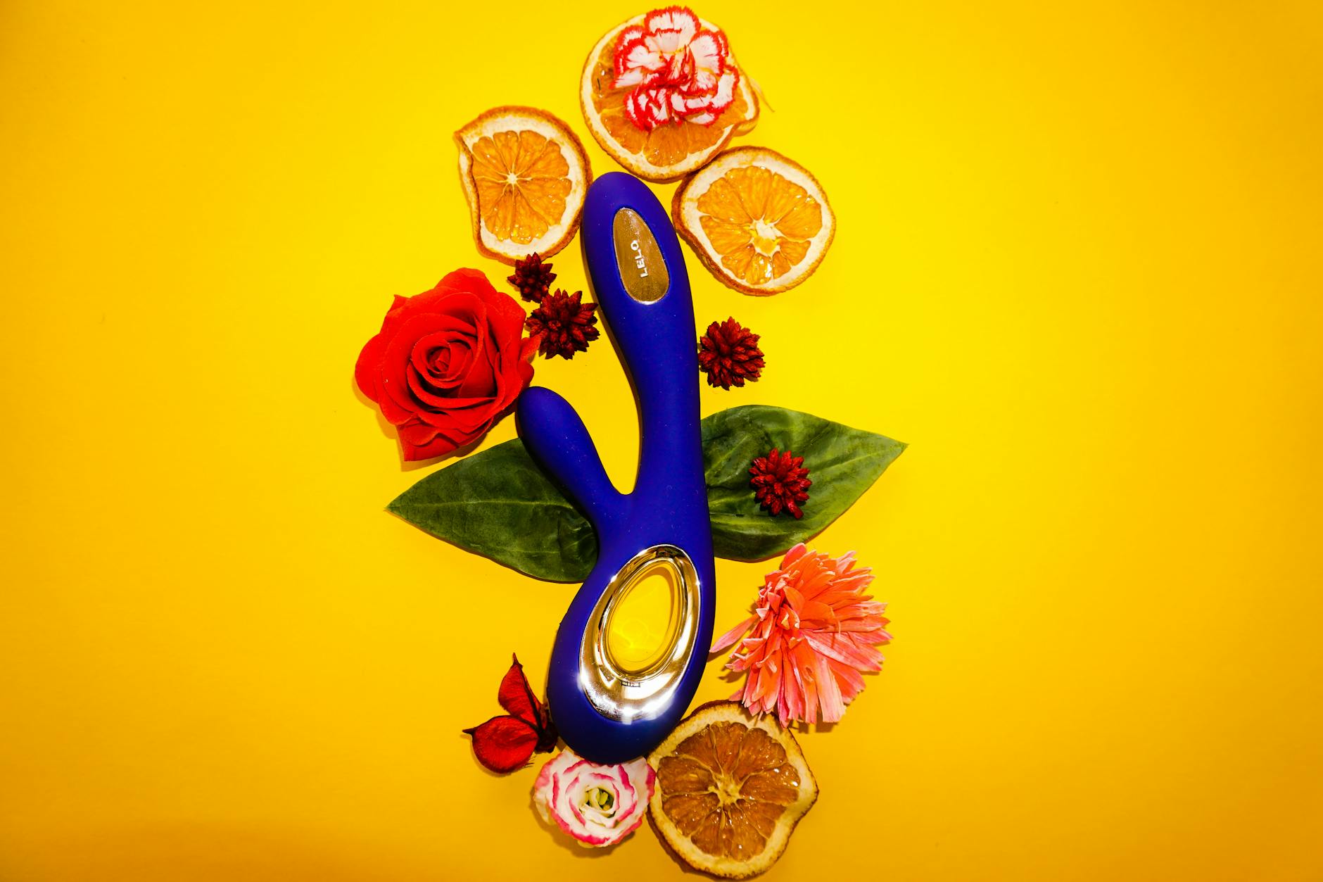 A vibrant collection of various sex toys on a black tray, featuring diverse shapes and colors.